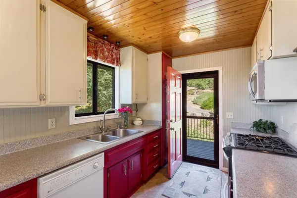 a spacious bathroom with a granite countertop sink and a large mirror
