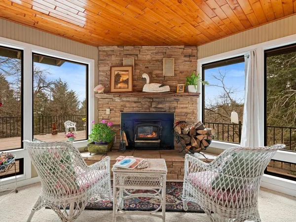 a living room with furniture a fireplace and a large window