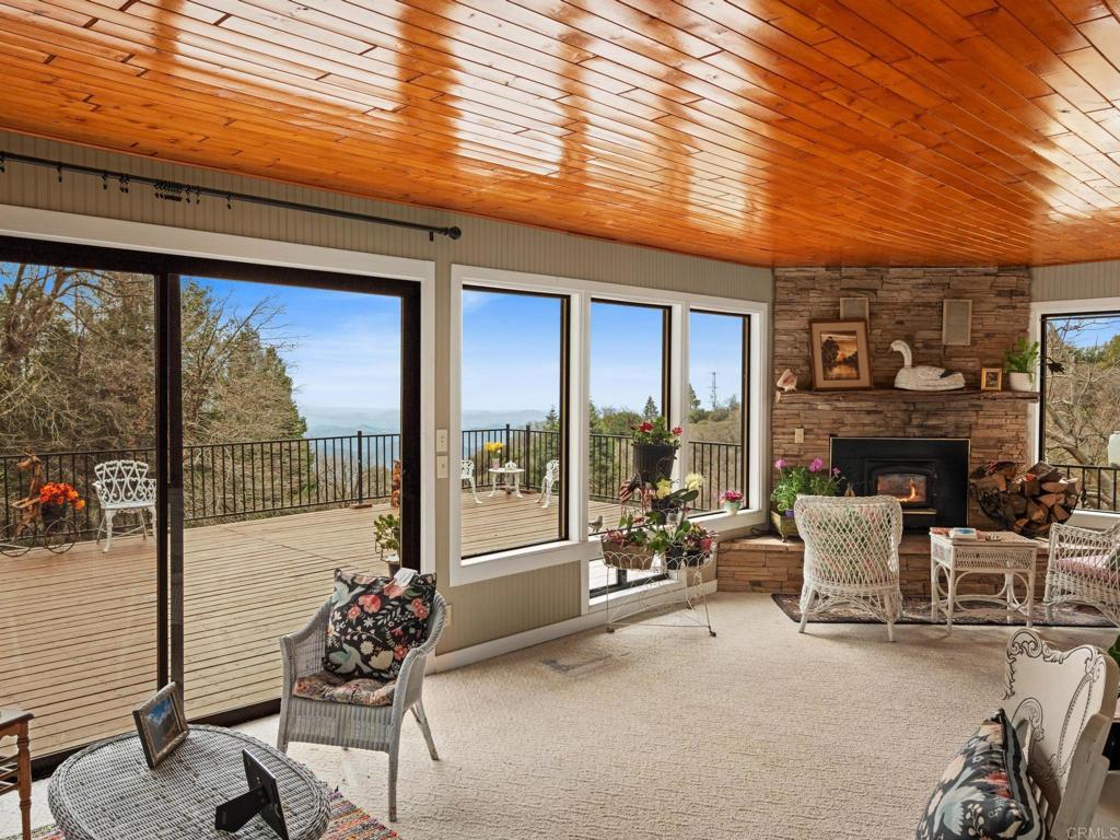 22209 Crestline Road Palomar Mountain, CA 92060 - Photo 22 of 51 a living room with furniture and a floor to ceiling window