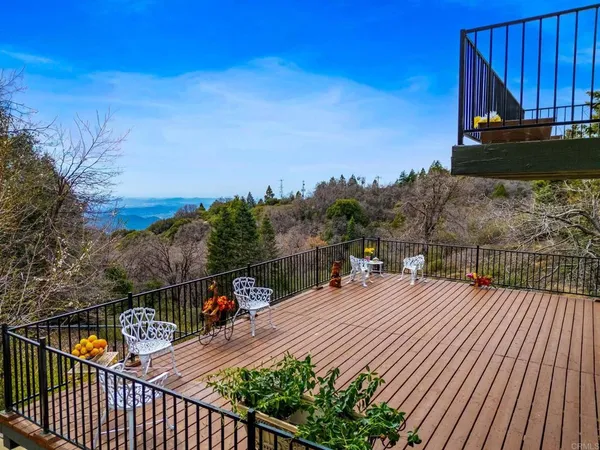 a view of a balcony with wooden floor and city view