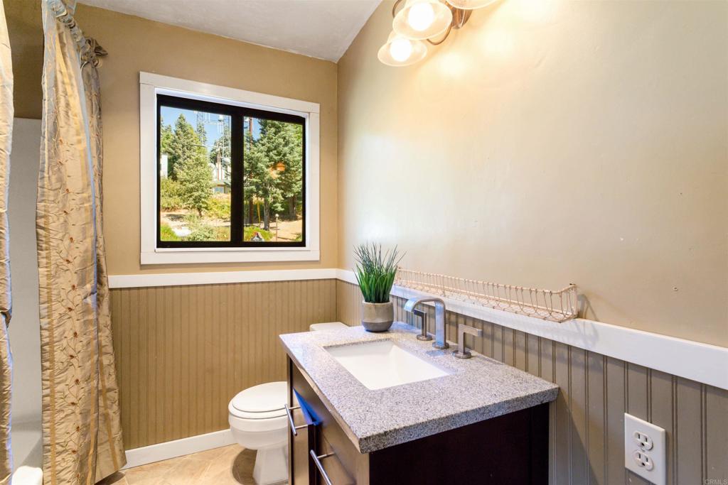 22209 Crestline Road Palomar Mountain, CA 92060 - Photo 30 of 51 a bathroom with a sink a toilet and a window