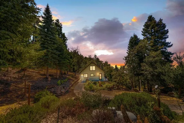 a view of a house with a tree in the background