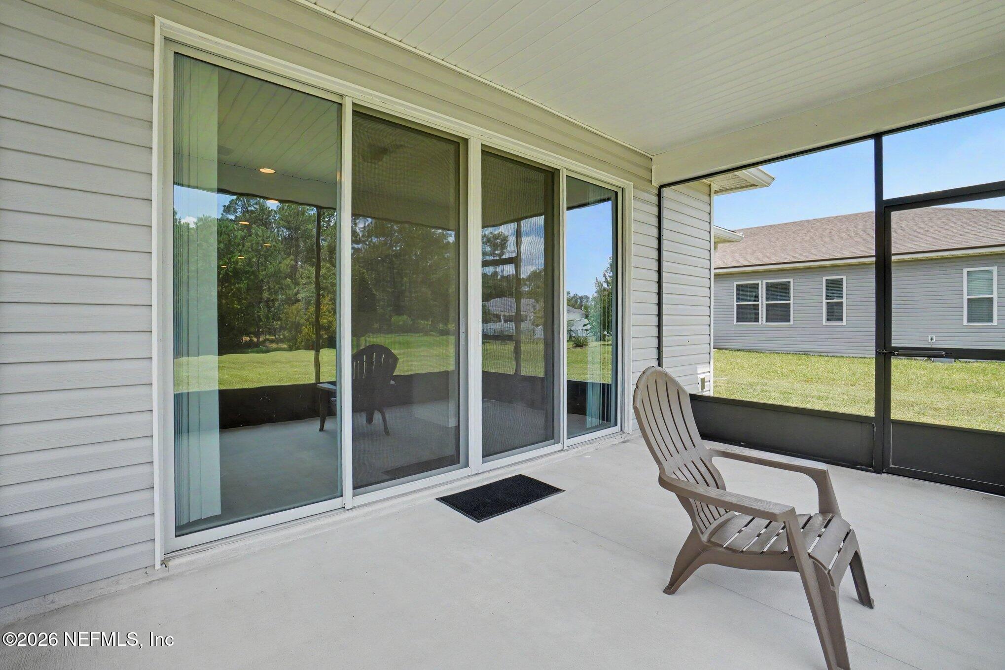 4630 Pine Ridge Parkway Middleburg, FL 32068 - Photo 27 of 35 a balcony with table and chairs