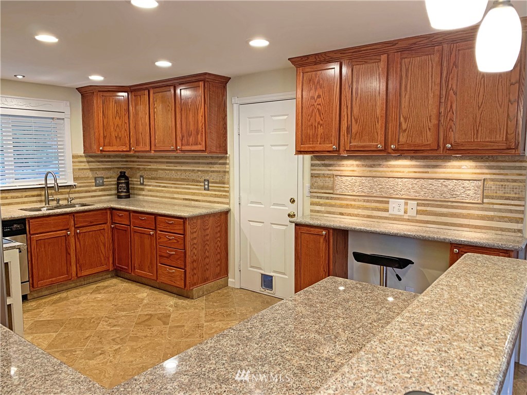 703 Bing Road, Unit A Lynnwood, WA 98036 - Photo 4 of 13 a kitchen with a sink and cabinets