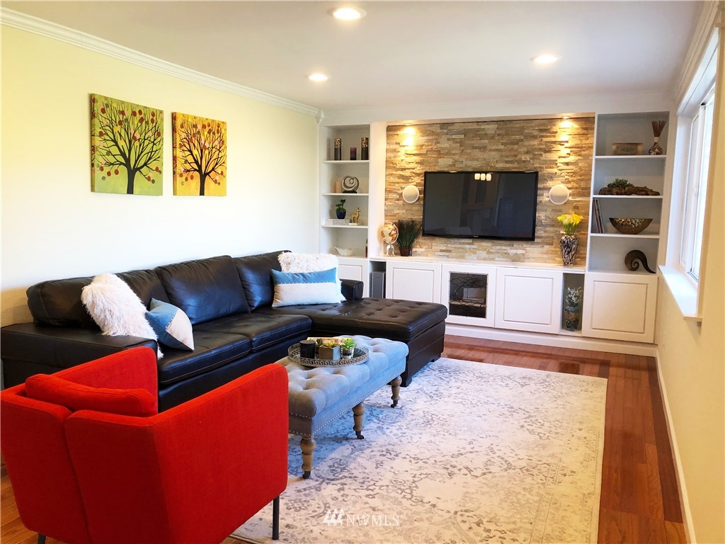703 Bing Road, Unit A Lynnwood, WA 98036 - Photo 6 of 13 a living room with furniture flat screen tv and a fireplace