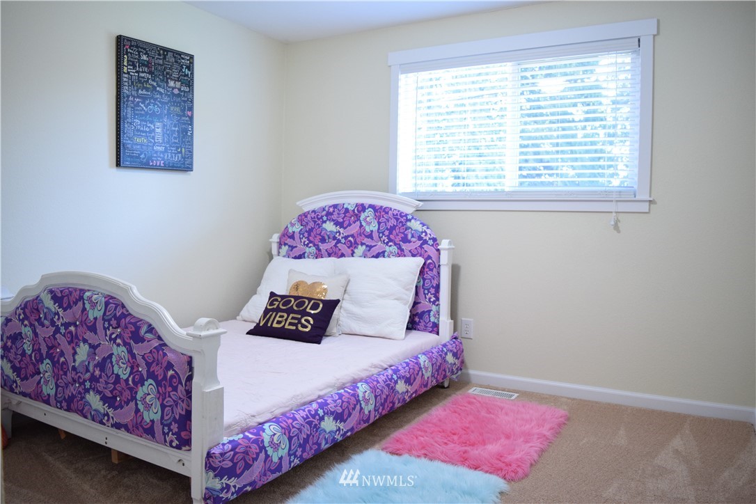 703 Bing Road, Unit A Lynnwood, WA 98036 - Photo 8 of 13 a bedroom with a bed and a window