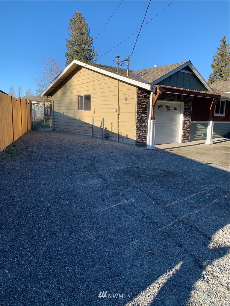 703 Bing Road, Unit A Lynnwood, WA 98036 - Photo 10 of 13 a front view of a house with a yard