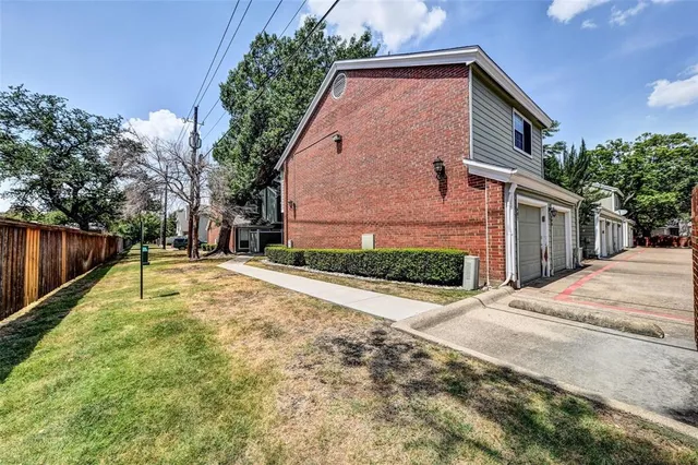 a view of backyard of house with green space