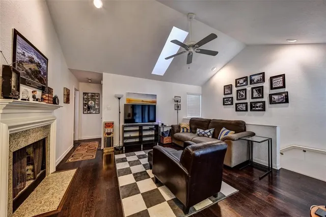 a living room with furniture a fireplace and wooden floor
