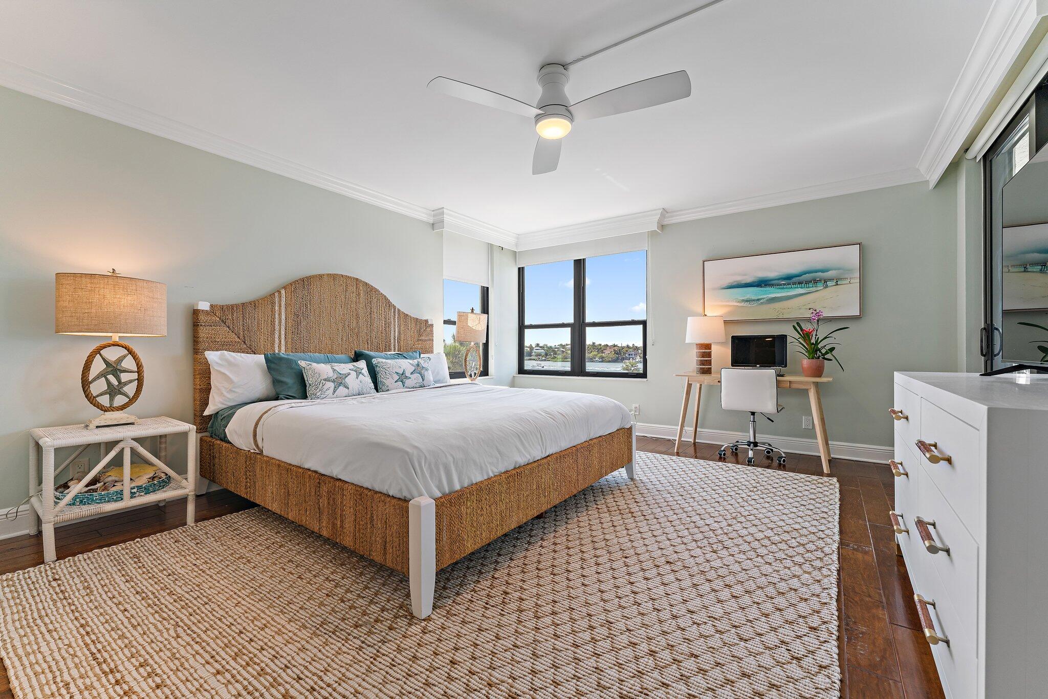 19670 South Beach Road, Unit B303 Jupiter, FL 33469 - Photo 40 of 104 a bedroom with a bed and a flat tv screen on dresser