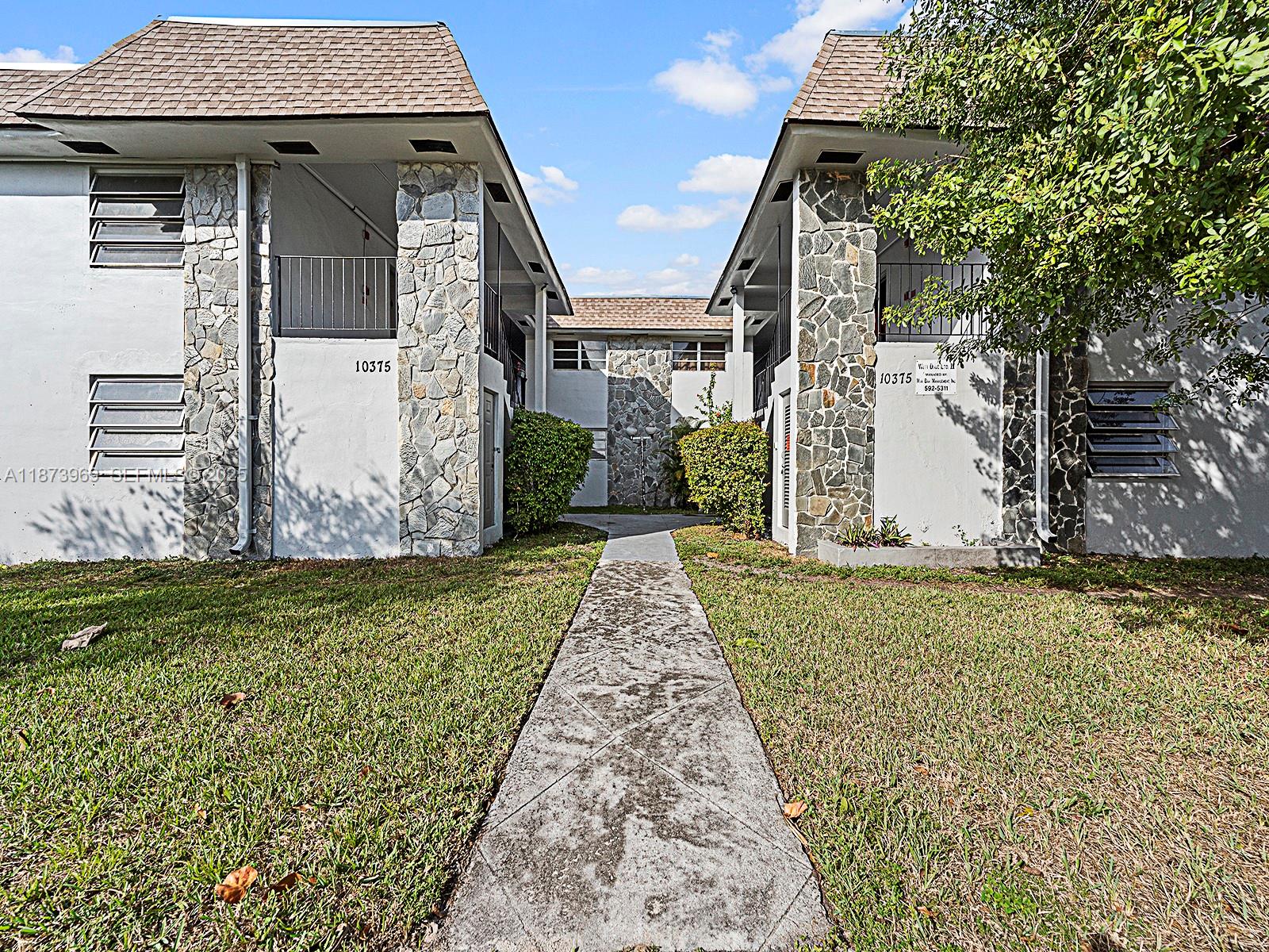 10305 Southwest 40th Street Miami, FL 33165 - Photo 1 of 5 a view of a house with a small yard