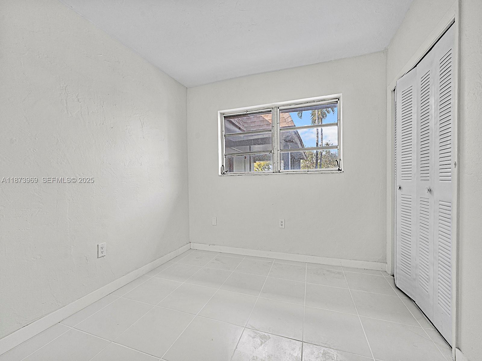 10305 Southwest 40th Street Miami, FL 33165 - Photo 3 of 5 an empty room with windows