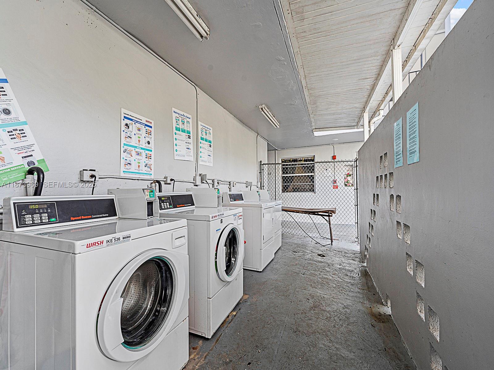 10305 Southwest 40th Street Miami, FL 33165 - Photo 5 of 5 a view of washer and dryer with kitchen in the background