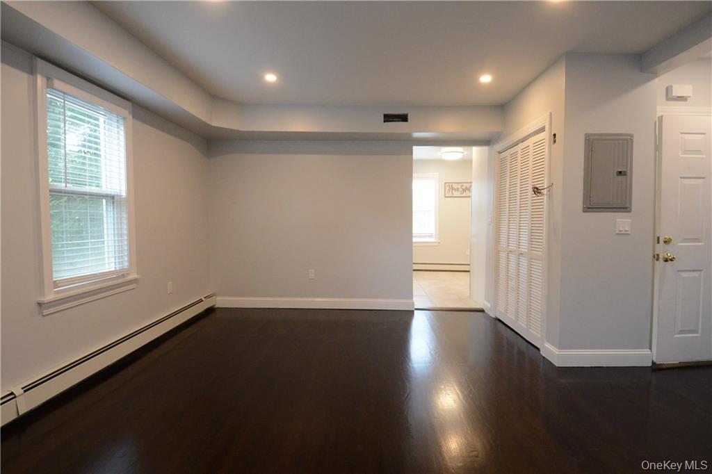 53 Dewitt Avenue, Unit 2 Bronxville, NY 10708 - Photo 2 of 19 an empty room with wooden floor and windows