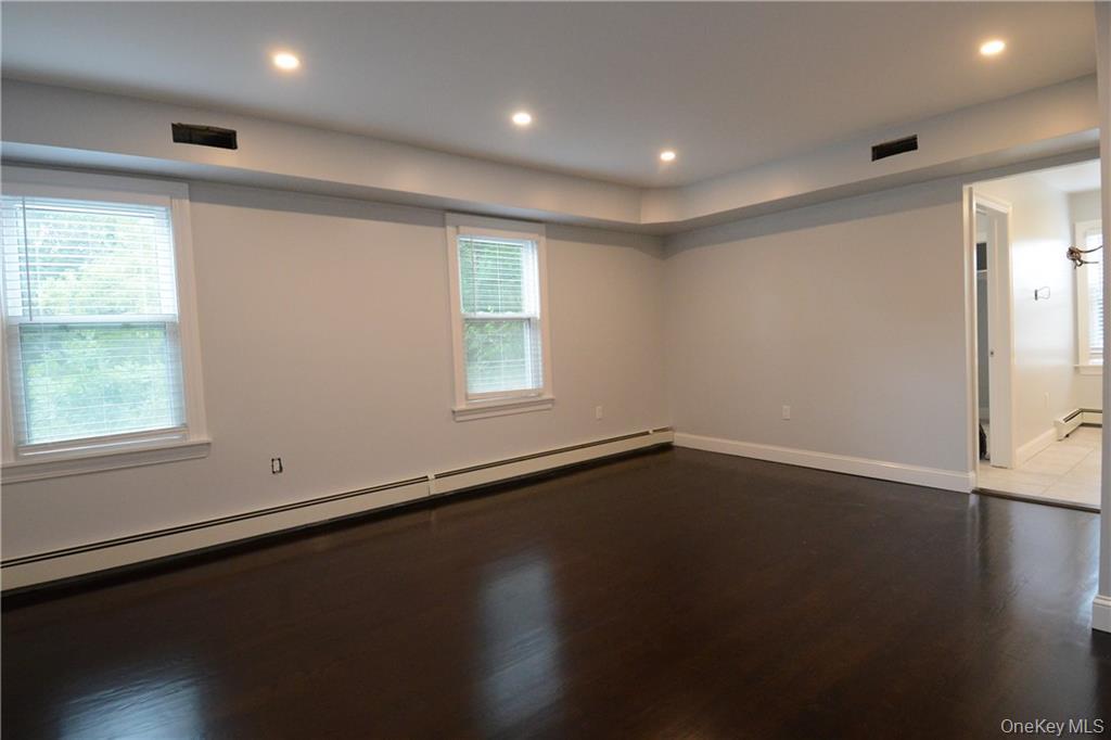53 Dewitt Avenue, Unit 2 Bronxville, NY 10708 - Photo 3 of 19 an empty room with wooden floor and windows