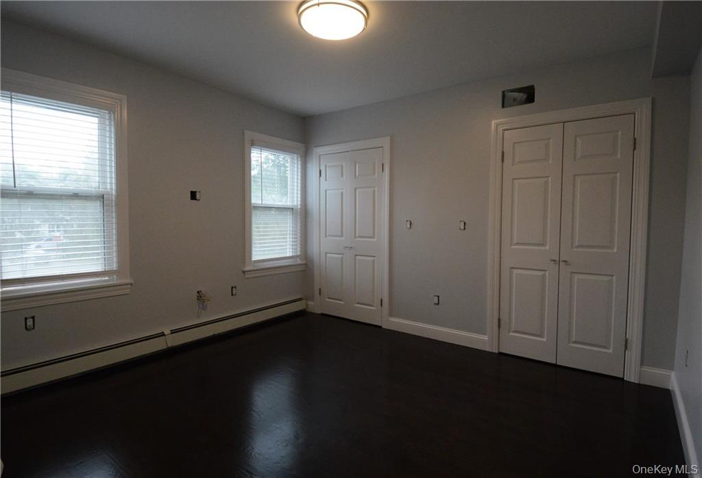 53 Dewitt Avenue, Unit 2 Bronxville, NY 10708 - Photo 5 of 19 an empty room with wooden floor and windows