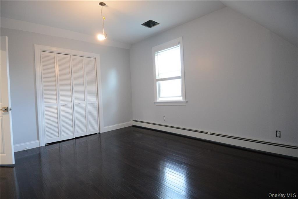 53 Dewitt Avenue, Unit 2 Bronxville, NY 10708 - Photo 6 of 19 an empty room with wooden floor and windows