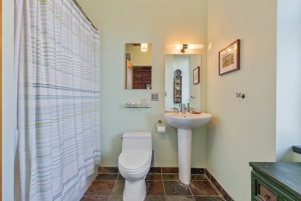 59 Commercial Wharf, Unit 1 Boston, MA 02110 - Photo 15 of 19 a bathroom with a sink toilet and shower