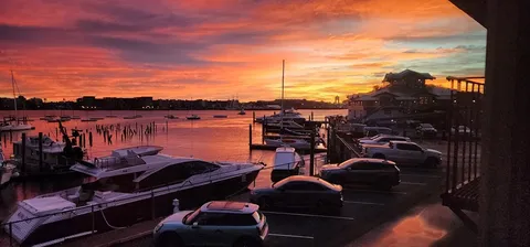 a view of a balcony with chairs and a potted plant