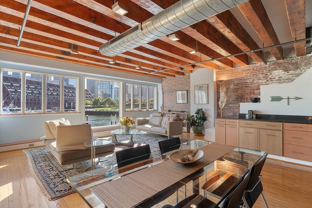 59 Commercial Wharf, Unit 1 Boston, MA 02110 - Photo 3 of 19 a living room with furniture and a window