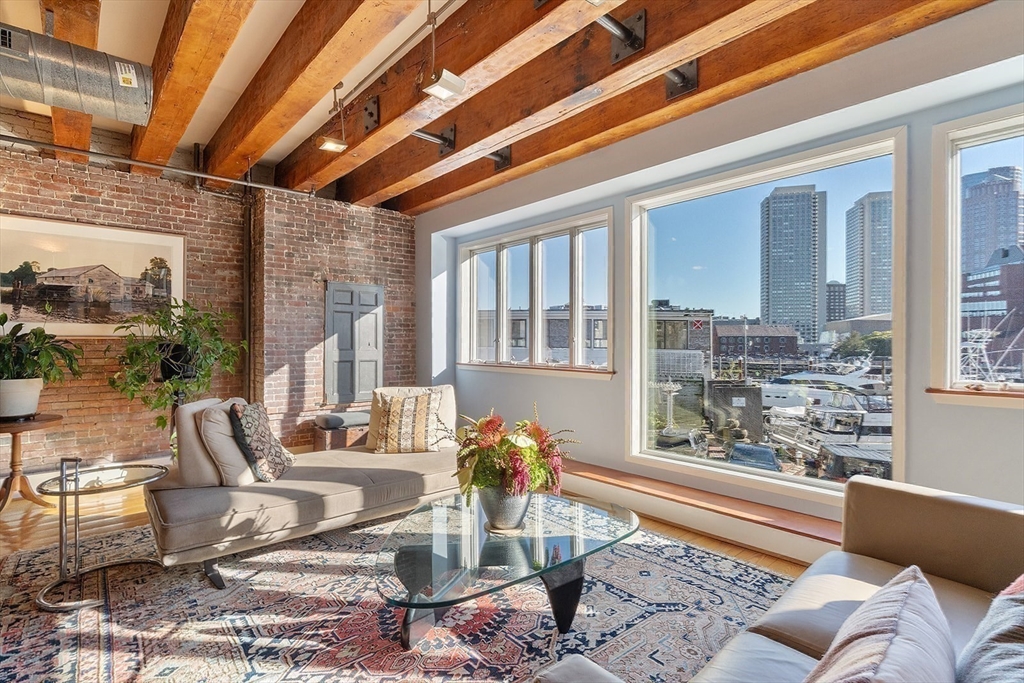 59 Commercial Wharf, Unit 1 Boston, MA 02110 - Photo 4 of 19 a living room with furniture and a large window