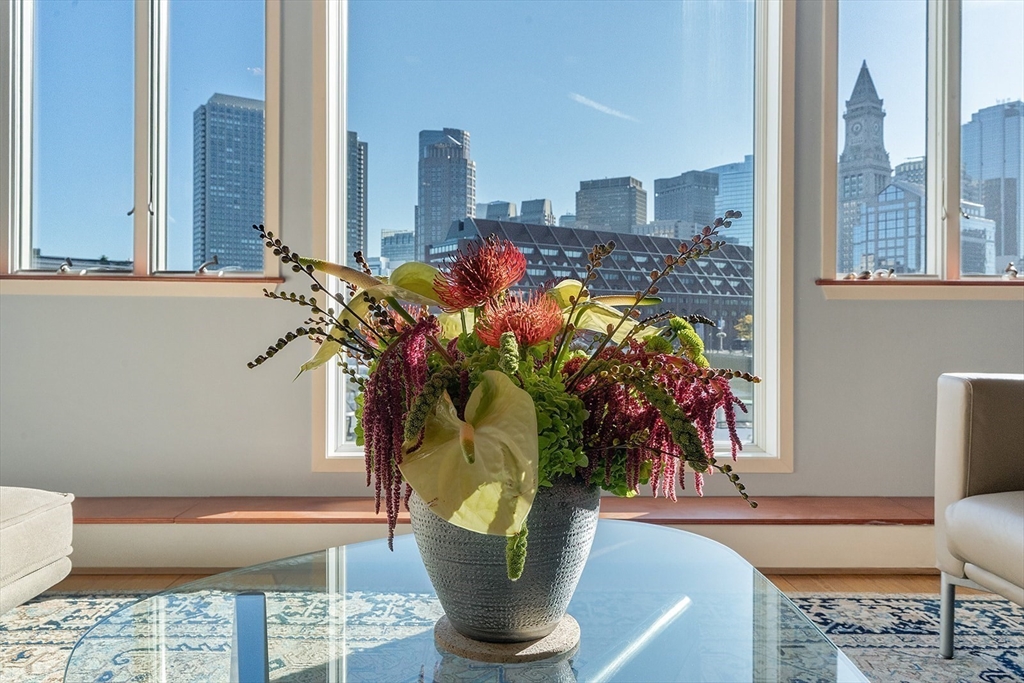 59 Commercial Wharf, Unit 1 Boston, MA 02110 - Photo 5 of 19 a vase of flowers sitting on a table with window