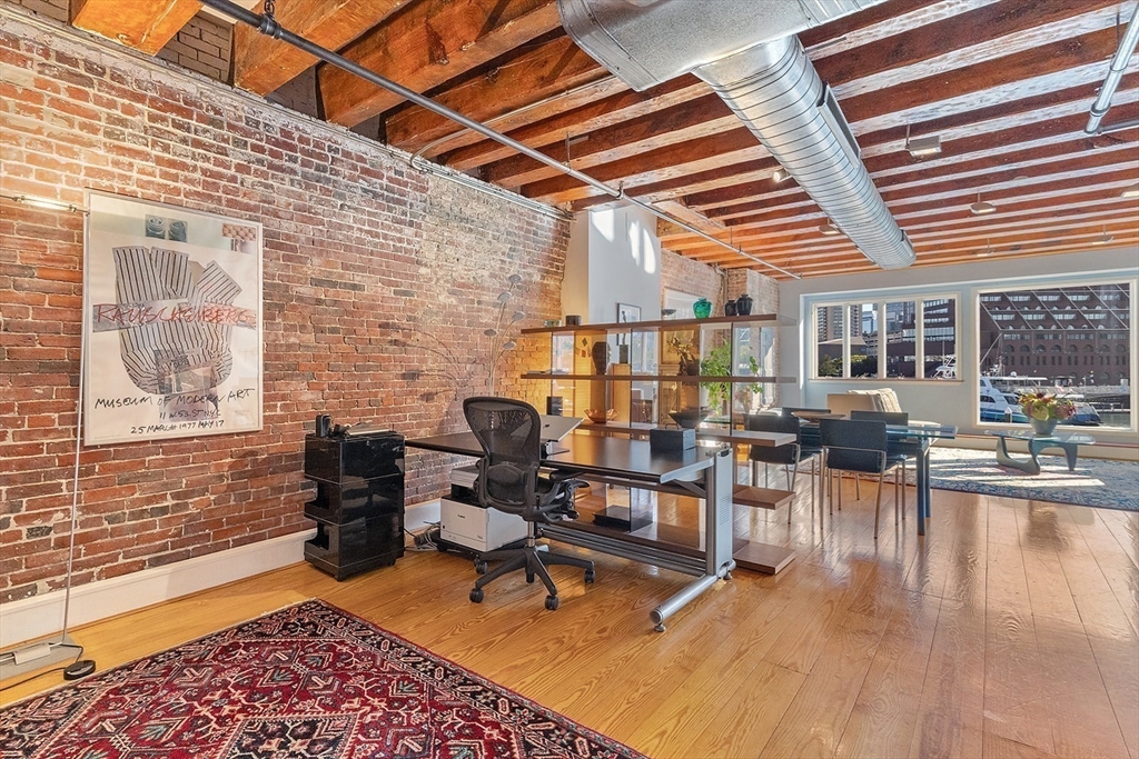 59 Commercial Wharf, Unit 1 Boston, MA 02110 - Photo 6 of 19 a balcony with furniture and wooden floor
