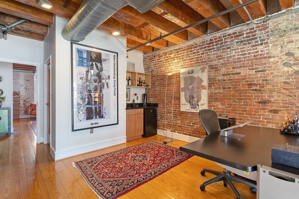 59 Commercial Wharf, Unit 1 Boston, MA 02110 - Photo 7 of 19 a view of a workspace with furniture