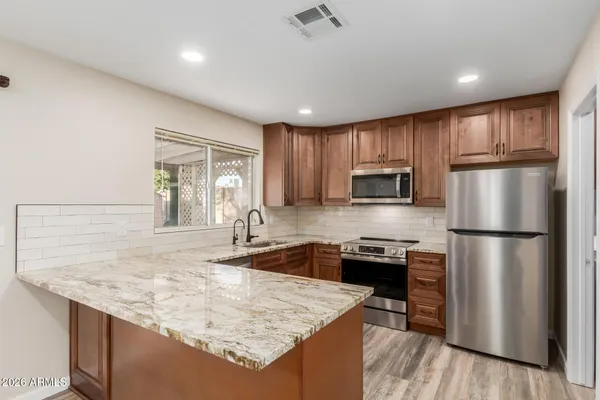 a kitchen with a refrigerator a stove a sink and a refrigerator