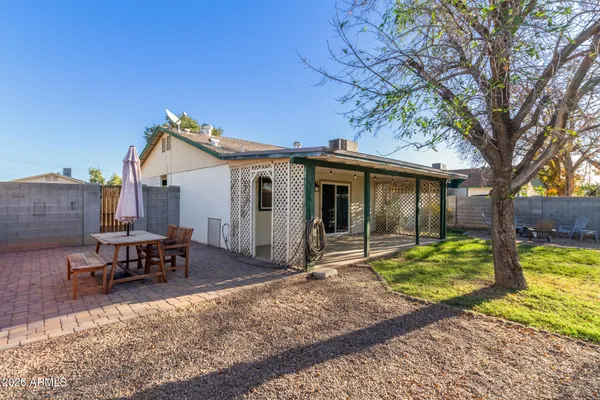 a view of a house with backyard and sitting area