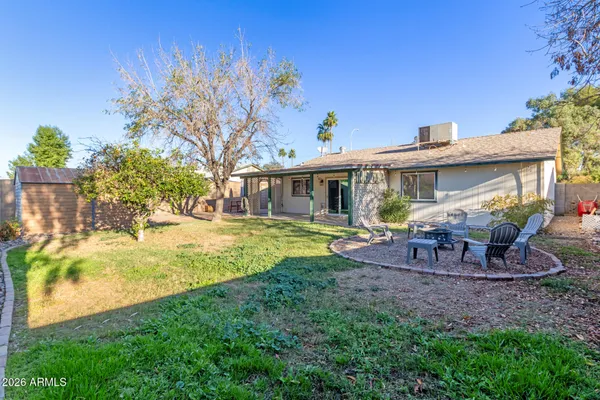a view of a house with backyard porch and sitting area