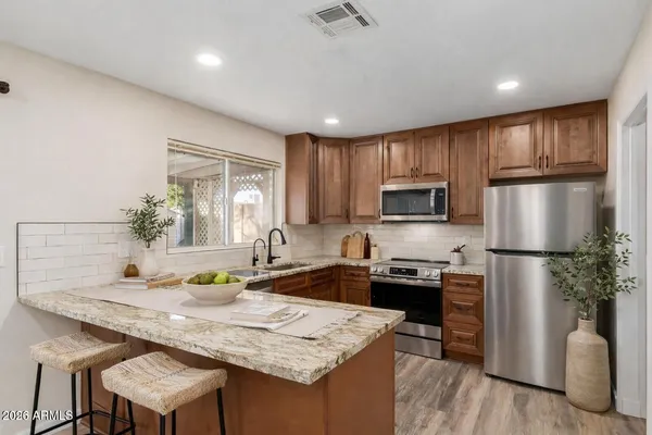 a kitchen with a refrigerator a stove a sink and a refrigerator