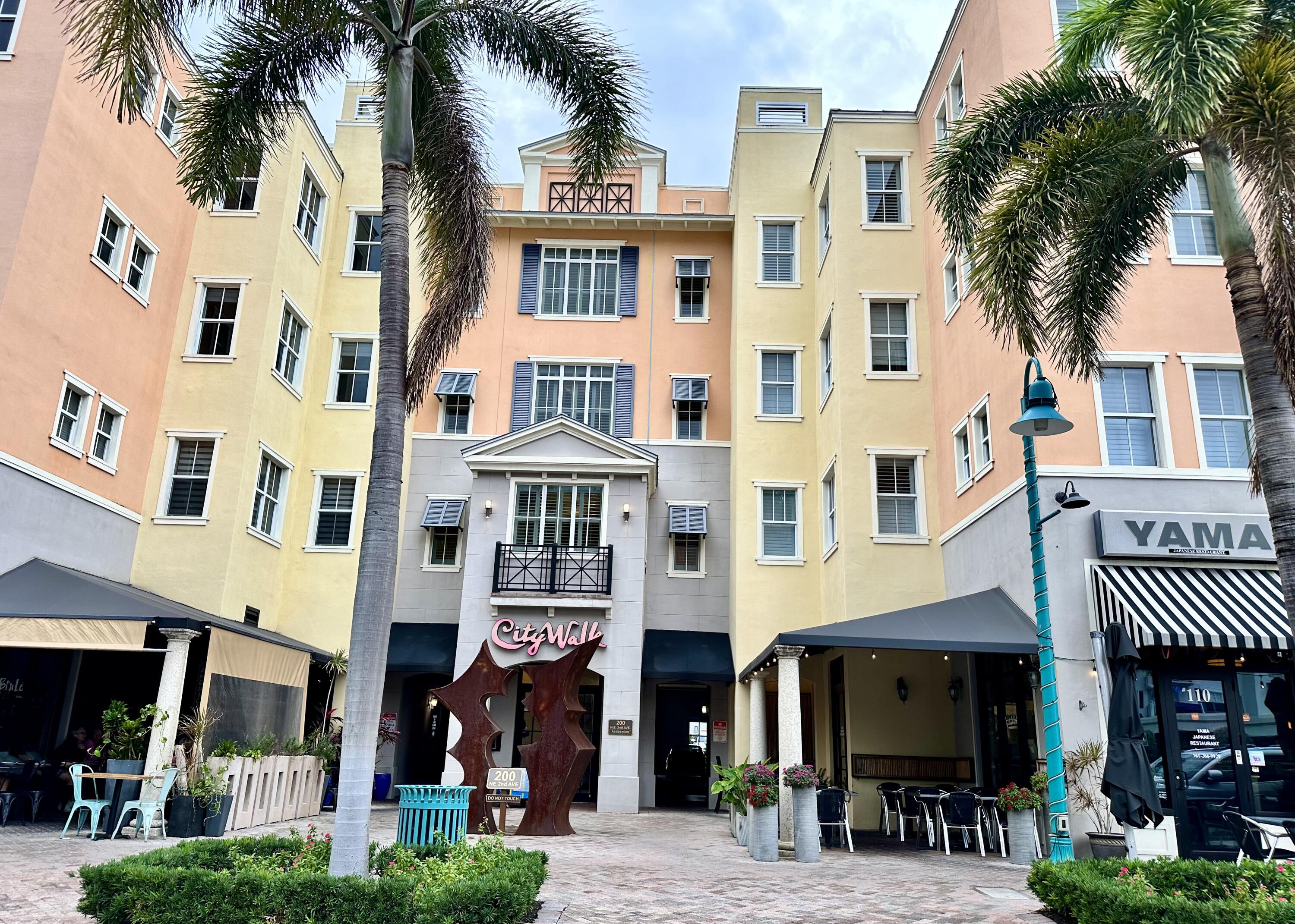 a front view of a large building and a yard