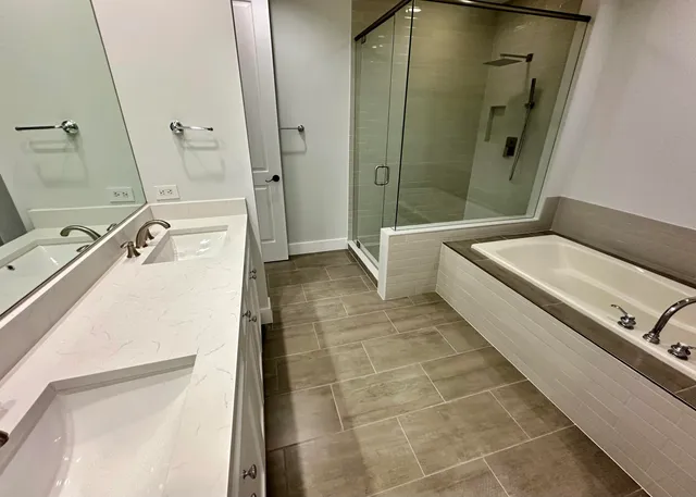 a bathroom with a granite countertop sink a toilet and shower