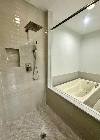 a bathroom with a tub and shower