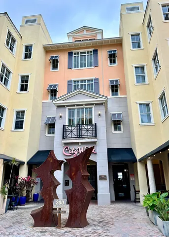 a front view of a building with glass windows and a table