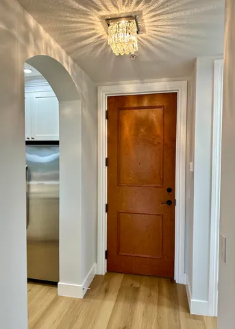 a view of a hallway with wooden floor