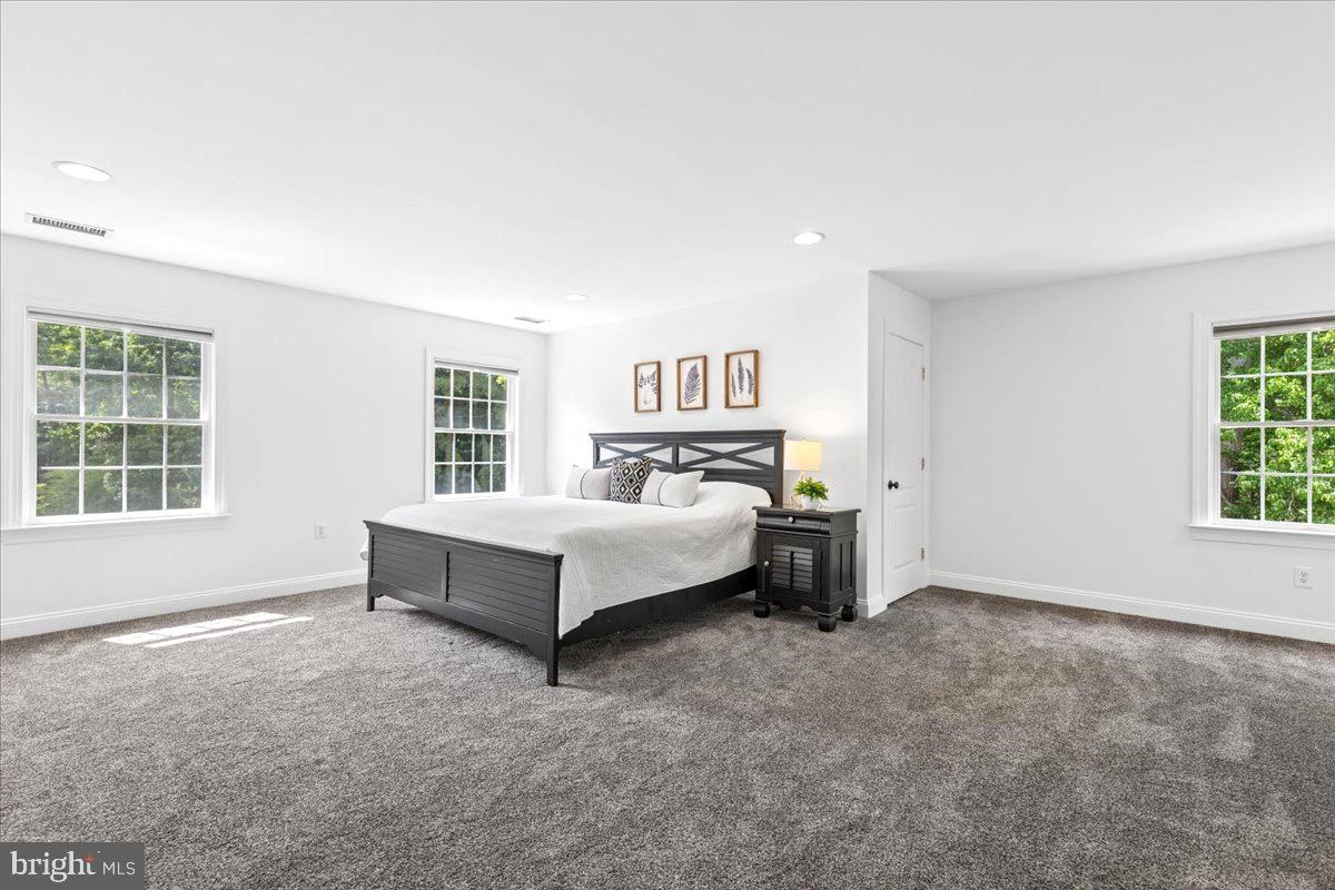 102 Little Neck Road Stevensville, MD 21666 - Photo 50 of 77 a spacious bedroom with a bed and a window