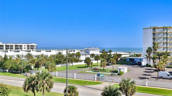 a bedroom with a bed and a potted plant