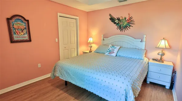 a bathroom with a granite countertop sink vanity mirror and toilet
