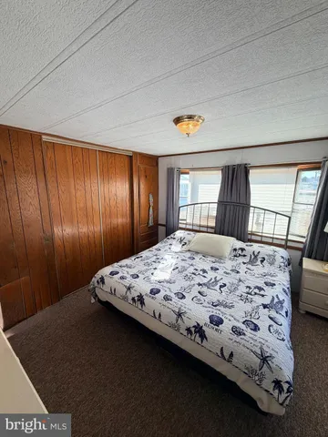 a bedroom with a bed and dresser