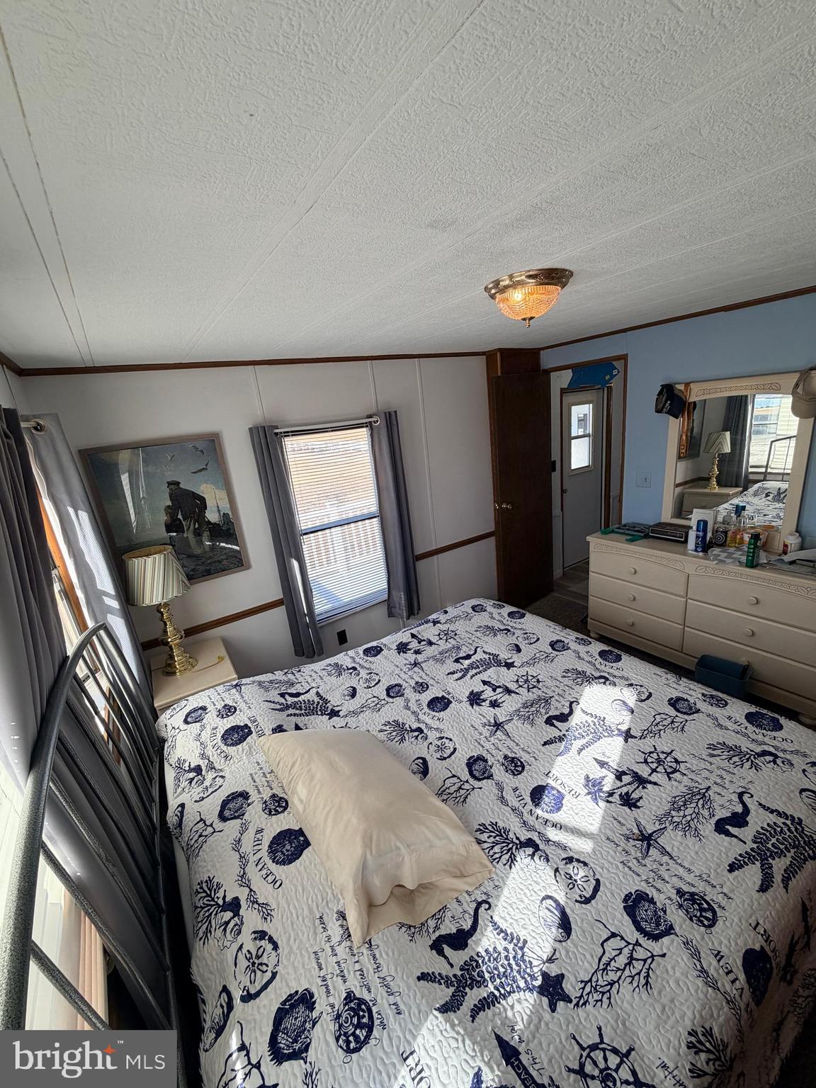 38267 Possum Road, Unit 271 Ocean View, DE 19970 - Photo 25 of 75 a bedroom with a bed and dresser