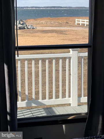 a view of a hallway with wooden floor and stairs