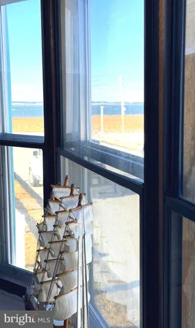 a room with gym equipment and large windows