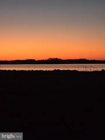 a view of a kitchen with refrigerator and cabinets