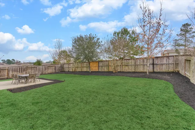 a view of a backyard with sitting area