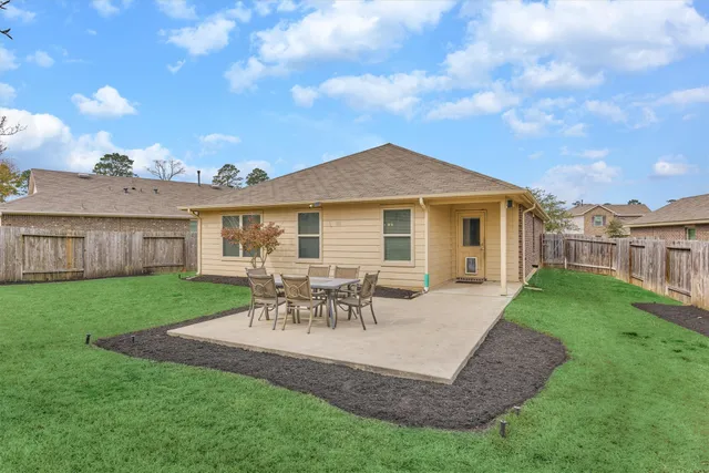 a view of a house with a backyard and a patio