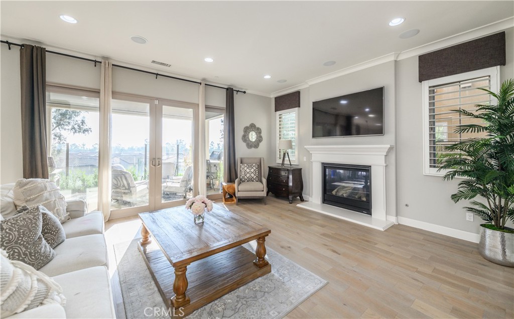 126 Long Fence Irvine, CA 92602 - Photo 17 of 61 a living room with furniture a large window and a fireplace