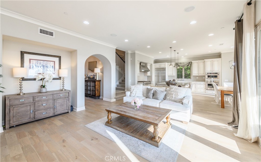 126 Long Fence Irvine, CA 92602 - Photo 18 of 61 a living room with kitchen island furniture and a kitchen view