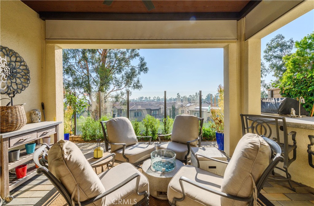 126 Long Fence Irvine, CA 92602 - Photo 19 of 61 a living room with patio furniture and a floor to ceiling window